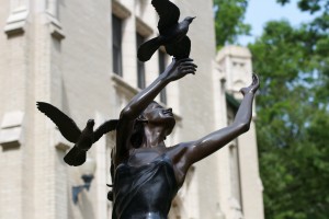 statue of lady with birds